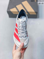 Top view of the shoe showing the white textile toe box, black-and-white patterned laces, and red side stripes.