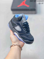 Black and gray kids' mid-top sneaker with blue collar lining and dark laces.