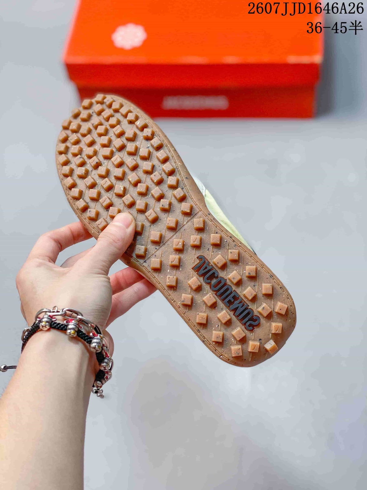 Underside view showing the gum-colored outsole with raised square traction lugs and Jacquemus branding.