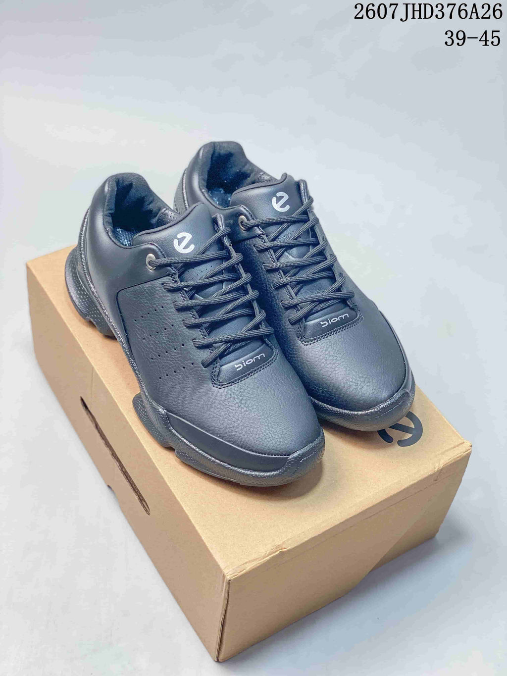 Black ECCO BIOM lace-up sneakers displayed on a shoebox; product code 2607JHD376A26 and size range 39–45 are visible at the top right.