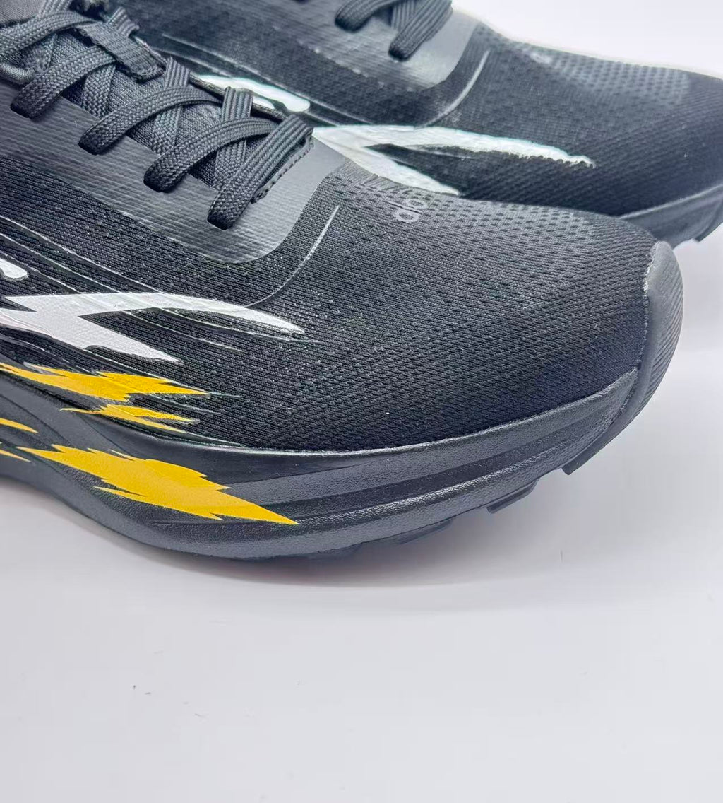 Close-up of the black textured upper, laces, toe area and layered graphic details.