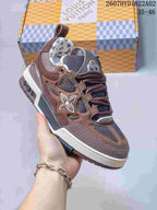 Close-up of a brown Trainer-style sneaker showing mesh panels, layered overlays, and a contrasting midsole.
