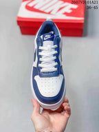 Top view of the sneaker showing white laces, a perforated toe panel and blue trim.
