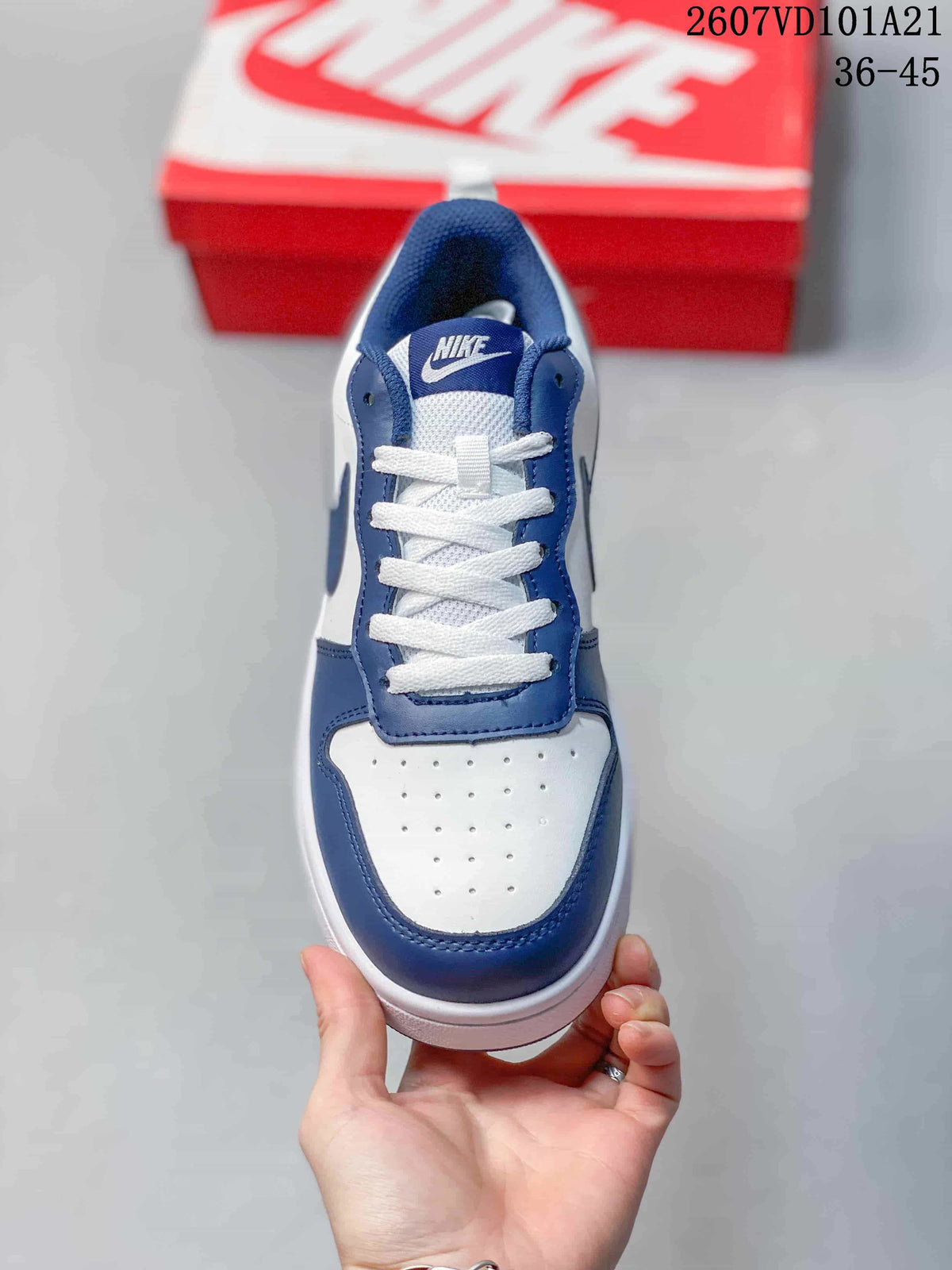 Top view of the sneaker showing white laces, a perforated toe panel and blue trim.