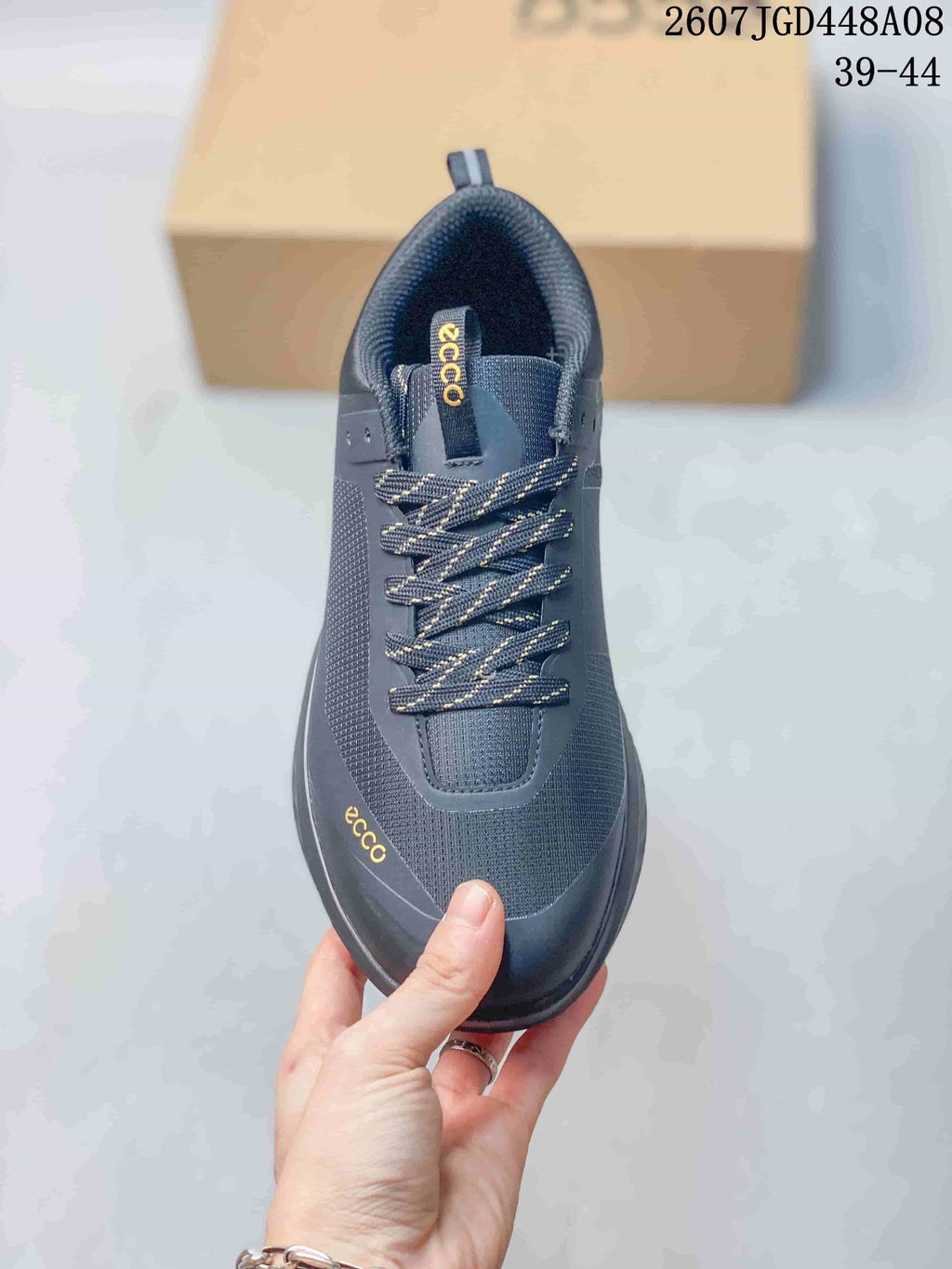 Top view of a dark gray ECCO sneaker showing the patterned laces, padded tongue, textured upper, and ECCO branding.
