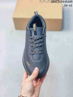 Top view of a dark gray ECCO sneaker showing the patterned laces, padded tongue, textured upper, and ECCO branding.
