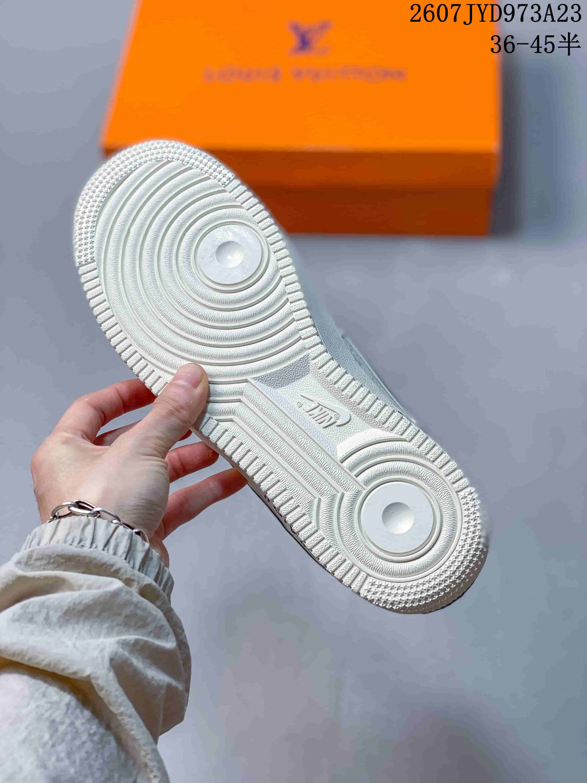 Close-up of the white rubber outsole showing its circular traction pattern and molded branding.