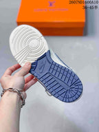 Close-up of the sneaker outsole showing a blue rubber tread with circular and geometric traction patterns.