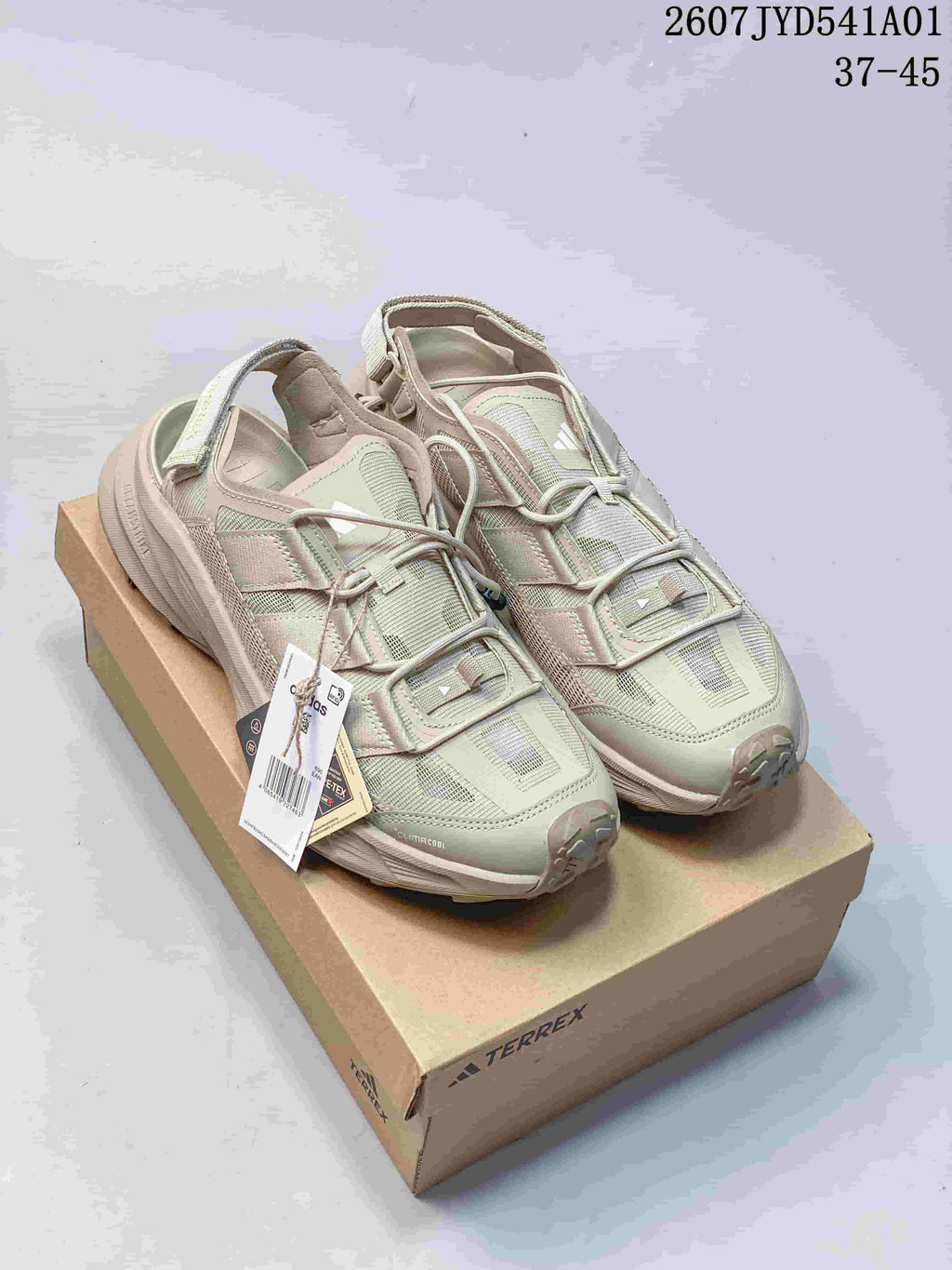 Pale green adidas Terrex outdoor shoes displayed on a box