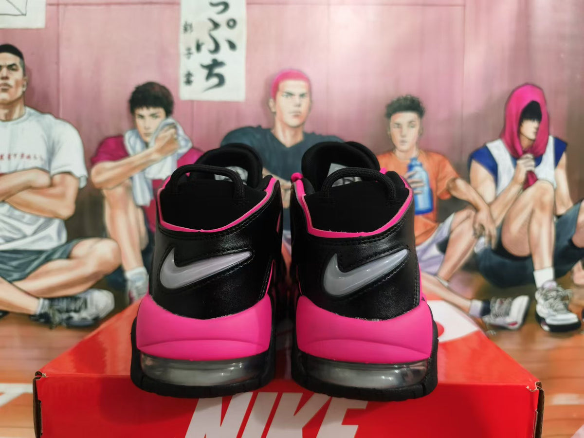 Rear view of black and bright pink Nike basketball sneakers with visible heel cushioning