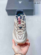 Top view of the shoe showing the lace-up construction, patterned upper, tongue label, and dark lace hardware.