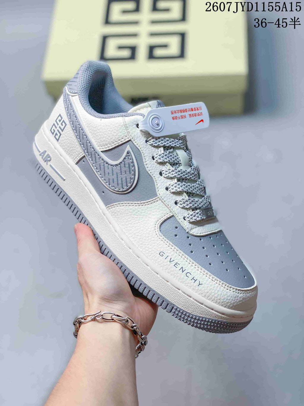 White and grey Nike Air Force 1 sneaker with patterned grey swoosh details, grey laces, and grey outsole accents.
