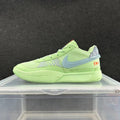 Side view of a lime-green Nike Ja 2 basketball shoe with a blue-gray Swoosh, mesh panels, and orange heel detail.