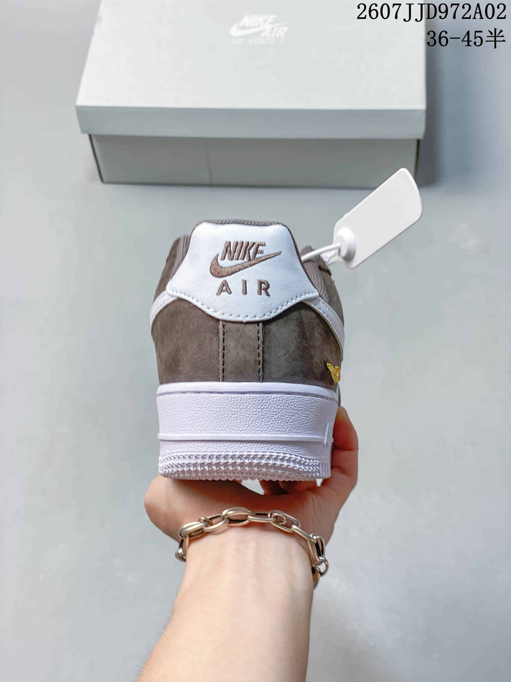 Rear view of the brown and white sneaker with a white heel tab and outsole; image overlay states 36–45.5 and JD972A02.