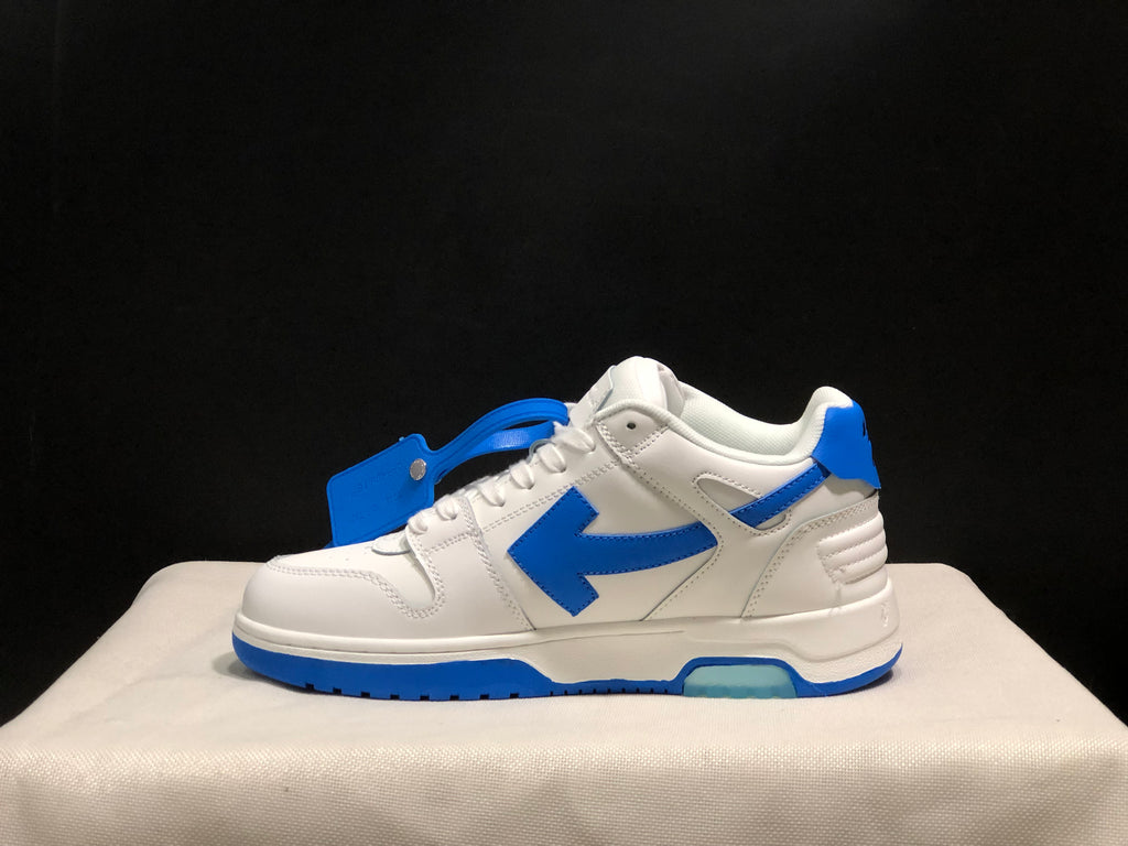 Side profile showing the white upper, blue arrow detail, layered panels, and blue outsole.