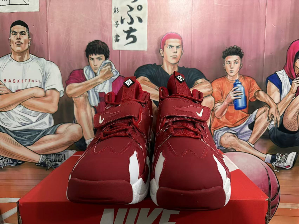 Front view of red Nike high-top sneakers with white toe accents, laces, ankle padding, and forefoot straps.