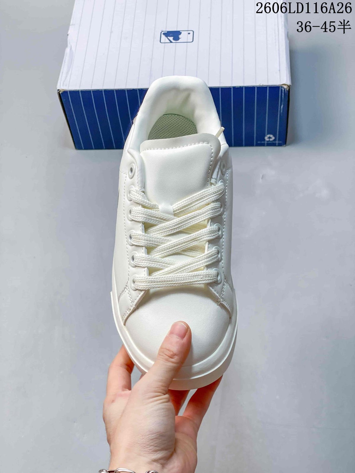 Top view of the white sneaker showing the lace-up closure, tongue and rounded toe.