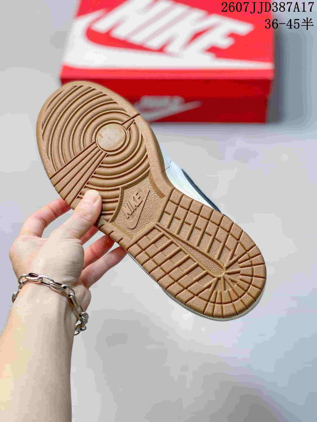 Close view of the gum-colored outsole showing concentric and grid-pattern traction details.