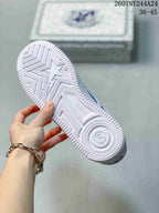 Close view of the white outsole with star-shaped and geometric tread details.