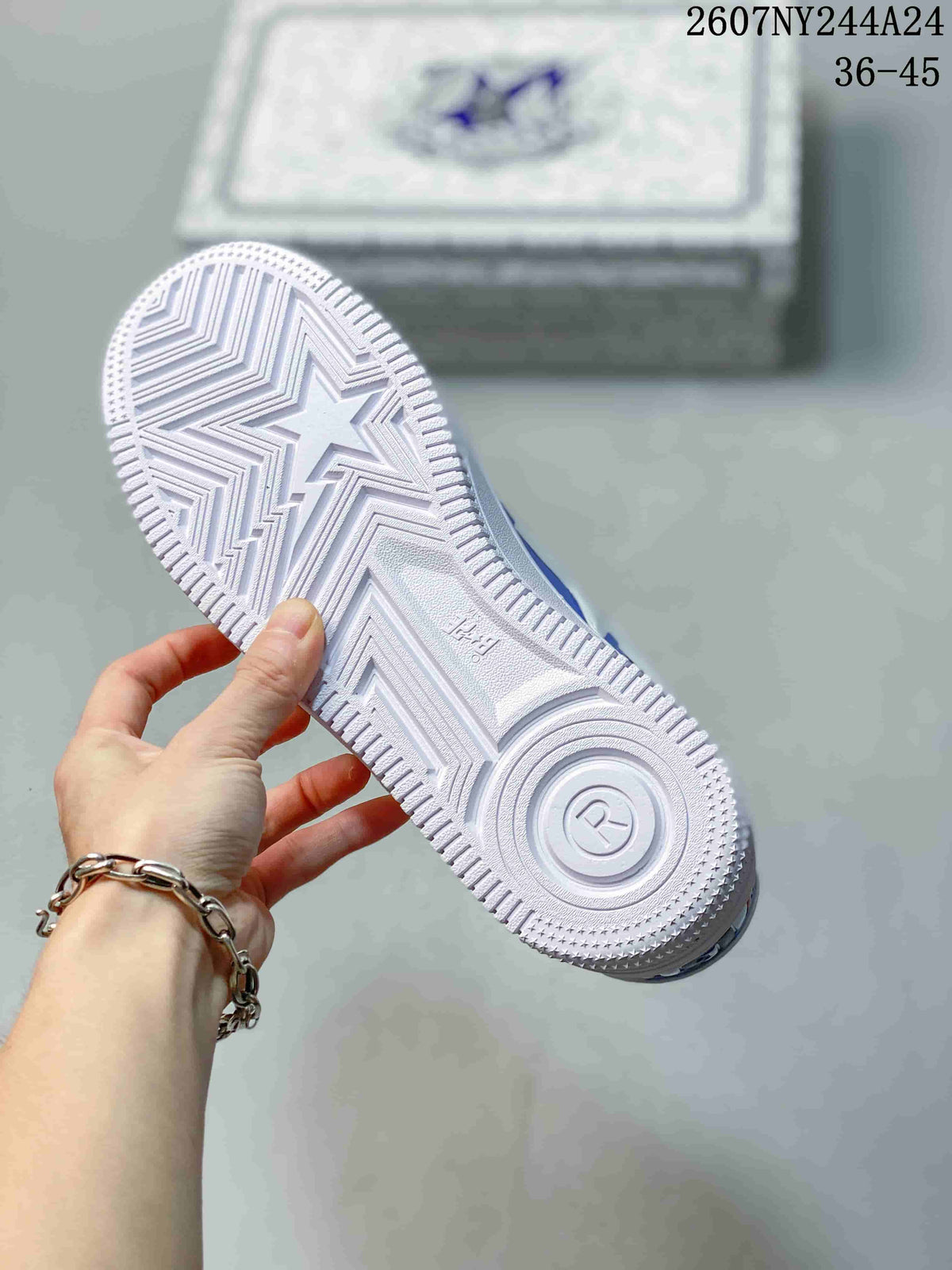 Close view of the white outsole with star-shaped and geometric tread details.