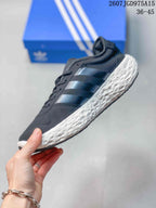 Side view showing the dark upper, three-stripe detailing, and textured white sole.