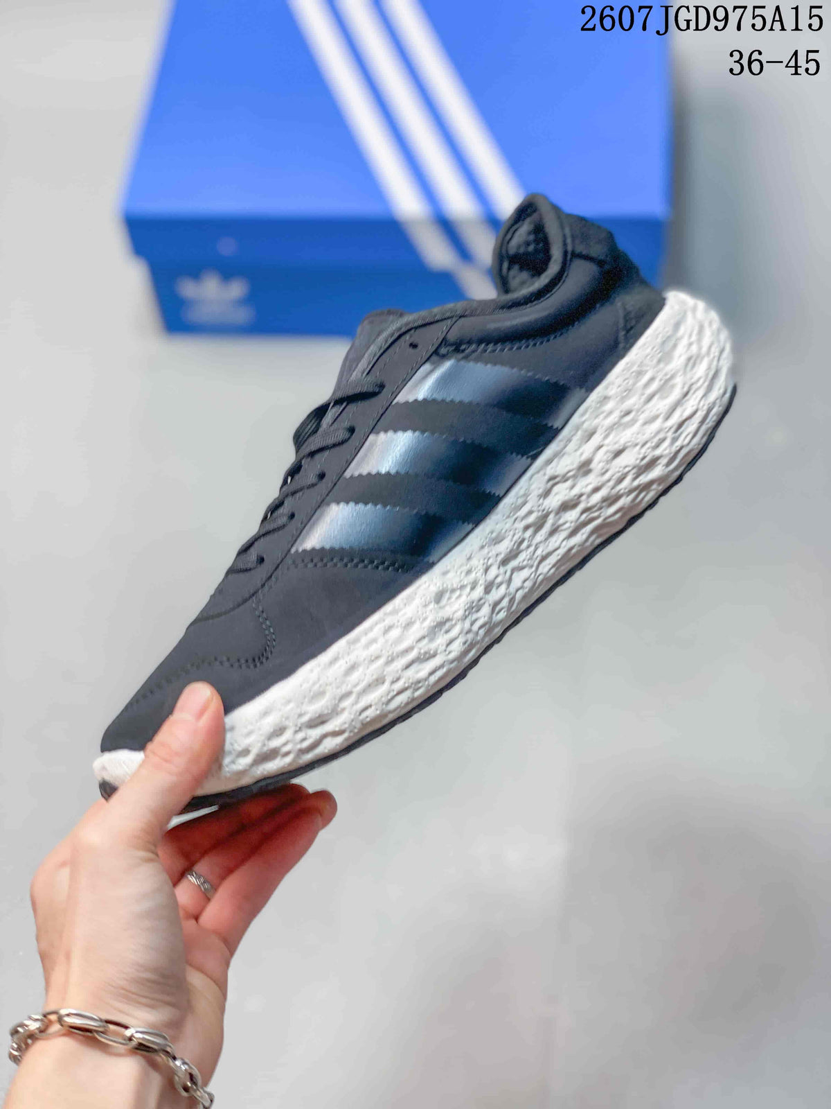 Side view showing the dark upper, three-stripe detailing, and textured white sole.