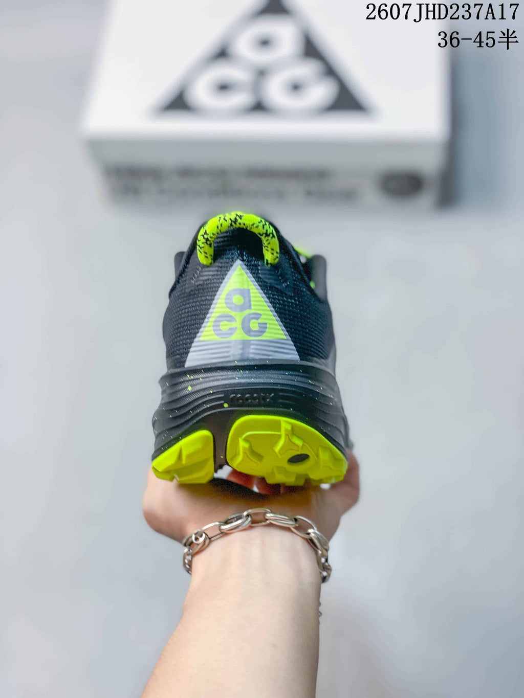 Rear view showing the ACG heel graphic, dark gray upper, and lime outsole sections.