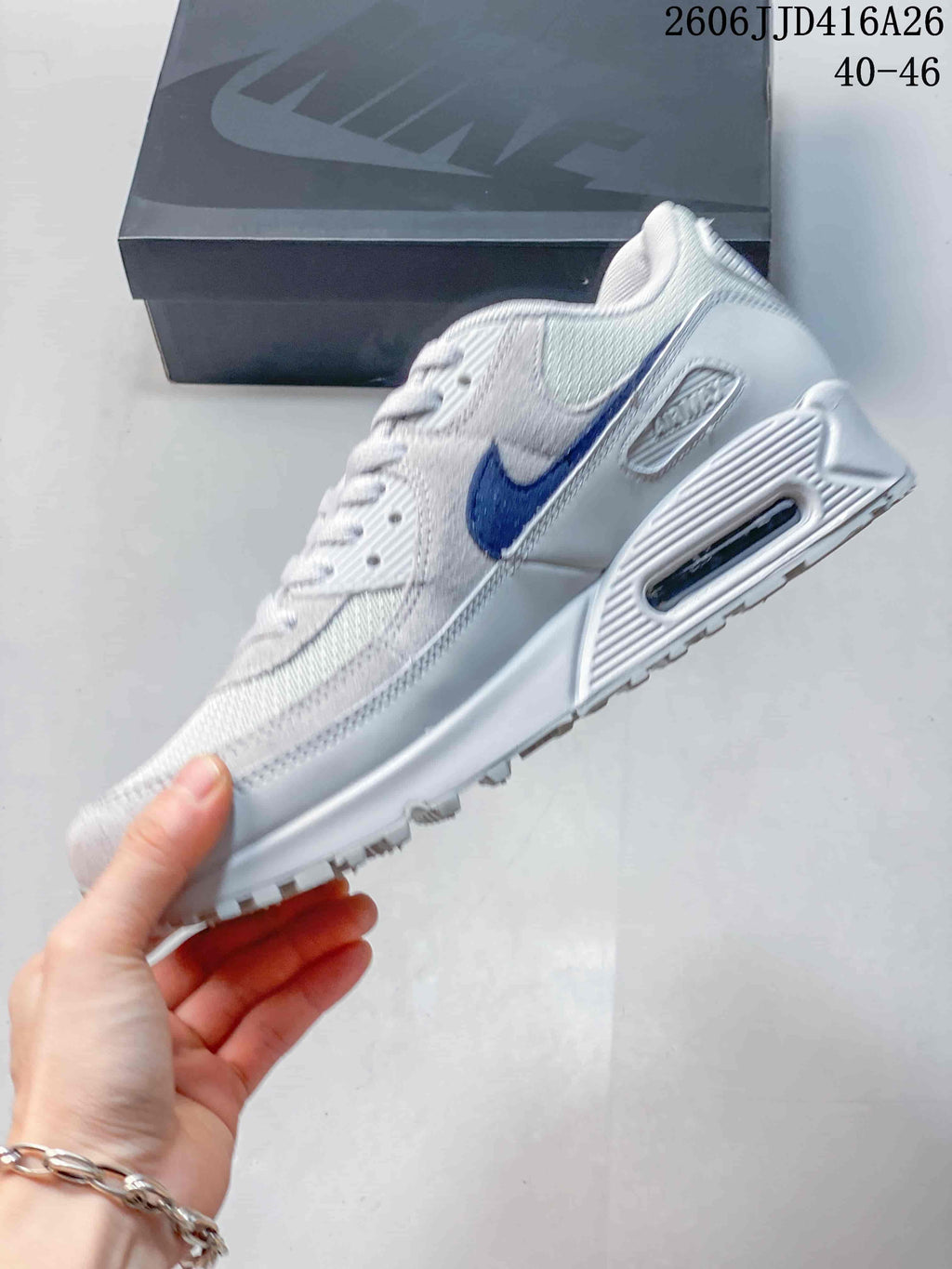 Side view of the white and blue sneaker showing the Swoosh, heel window detail, and textured outsole.