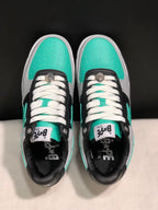 Top-down view showing turquoise perforated toe boxes, white laces and black lace panels.