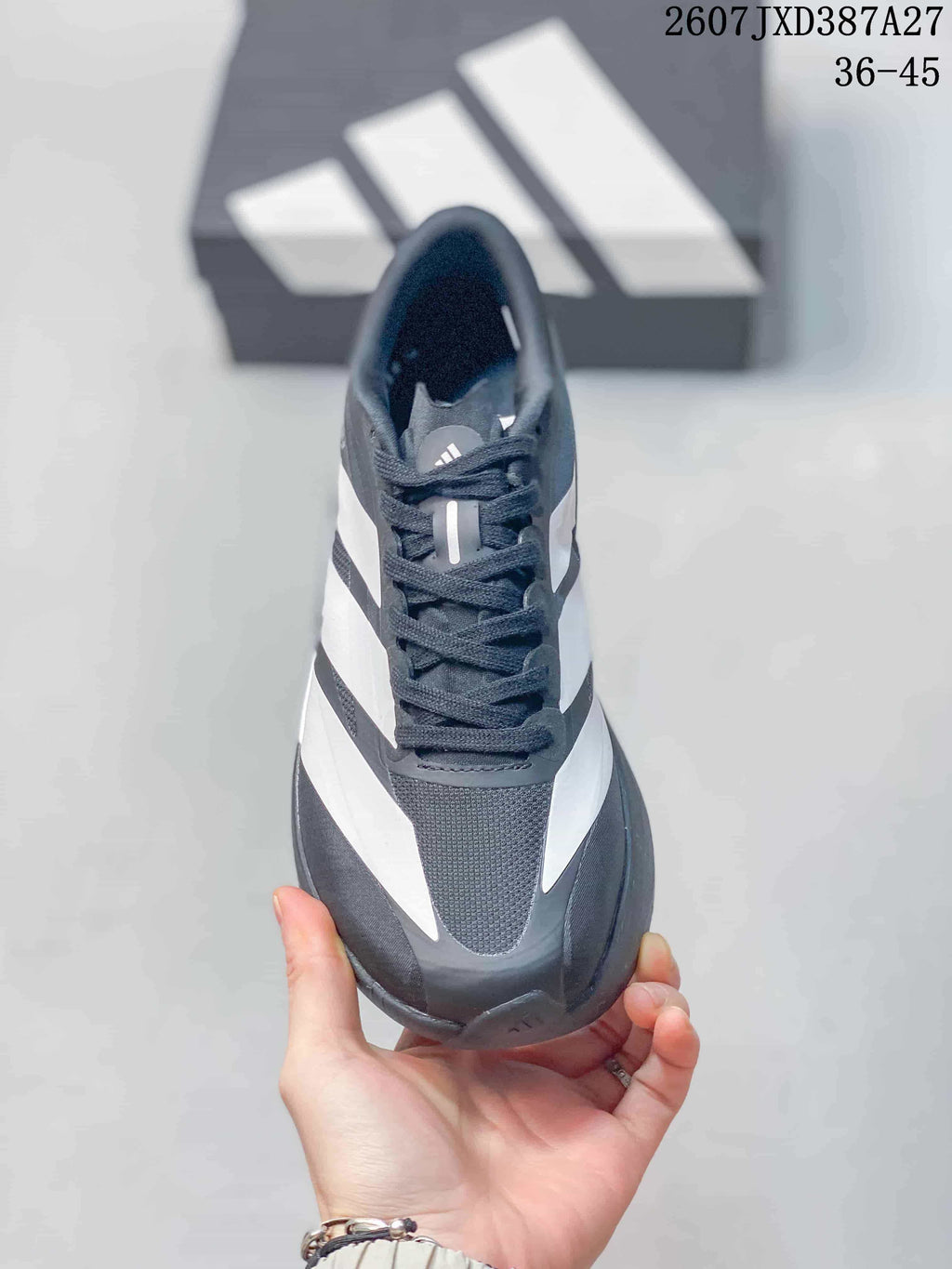Top view of the sneaker showing black laces, a textured toe panel and contrasting white side detailing.