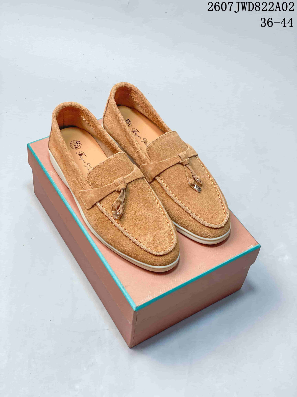 Tan slip-on loafers with moc-toe stitching, strap and tassel details