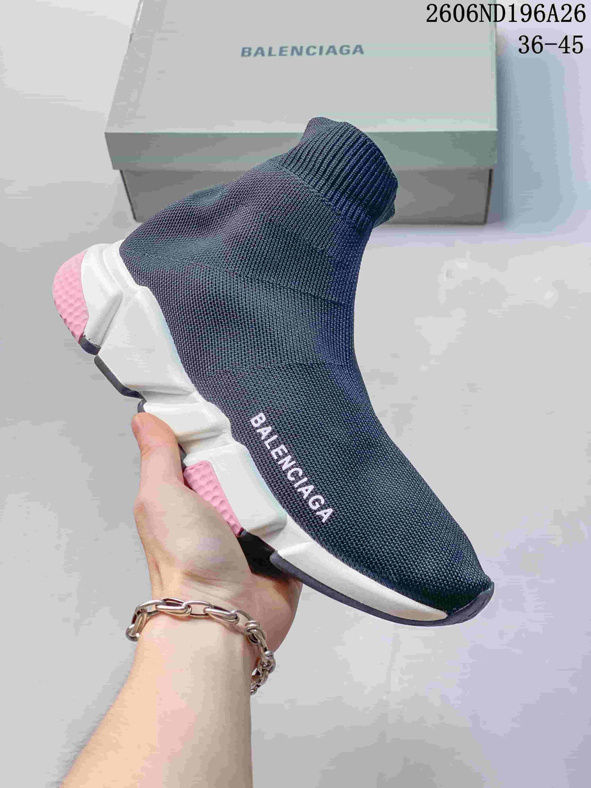 Dark knit sock-style sneaker with a white sole and pink accent blocks.