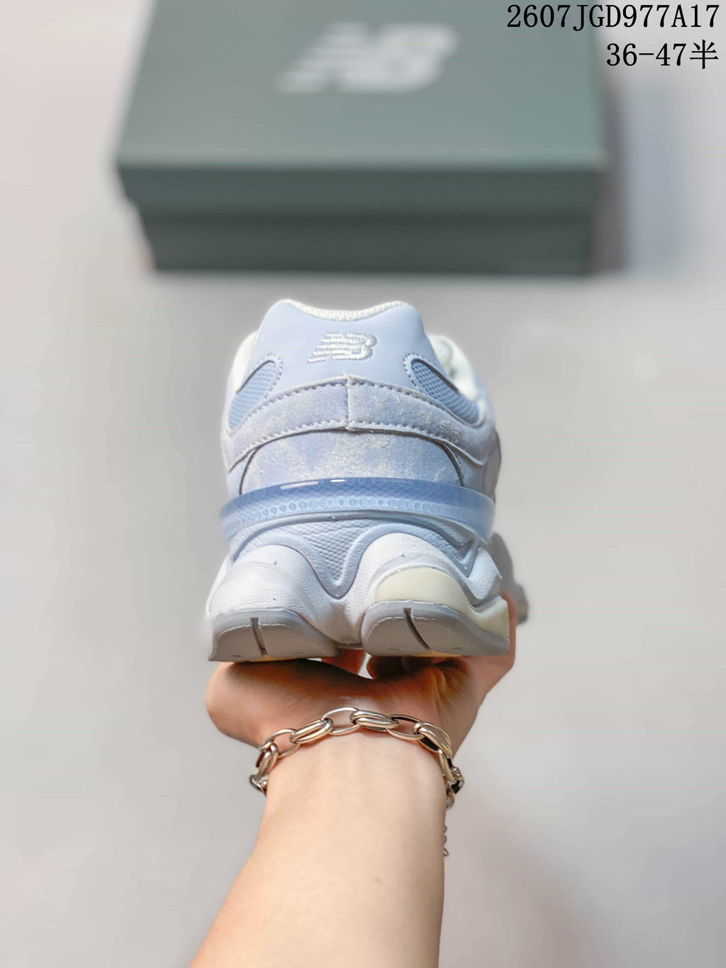 Rear view of the light blue New Balance 9060 sneaker showing the padded heel and layered midsole.