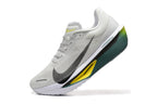 Close view of an off-white Nike Zoom Fly 6 shoe with dark green and yellow midsole details