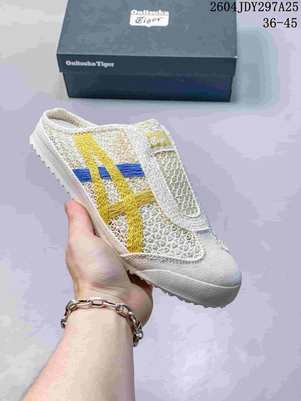 White Onitsuka Tiger Mexico 66 Sabot slip-on sneaker with yellow and blue contrasting stripes.