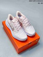 Pair of pale pink and white Nike Zoom Winflo 8 sneakers displayed on an orange shoebox, with the style code and size range visible above.