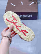 Close-up of the textured cream outsole with red graphic details