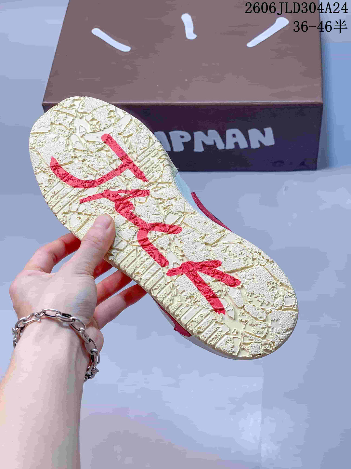 Close-up of the textured cream outsole with red graphic details