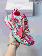 Angled side view of the red, white, and turquoise sneaker with graphic overlays and mesh construction.