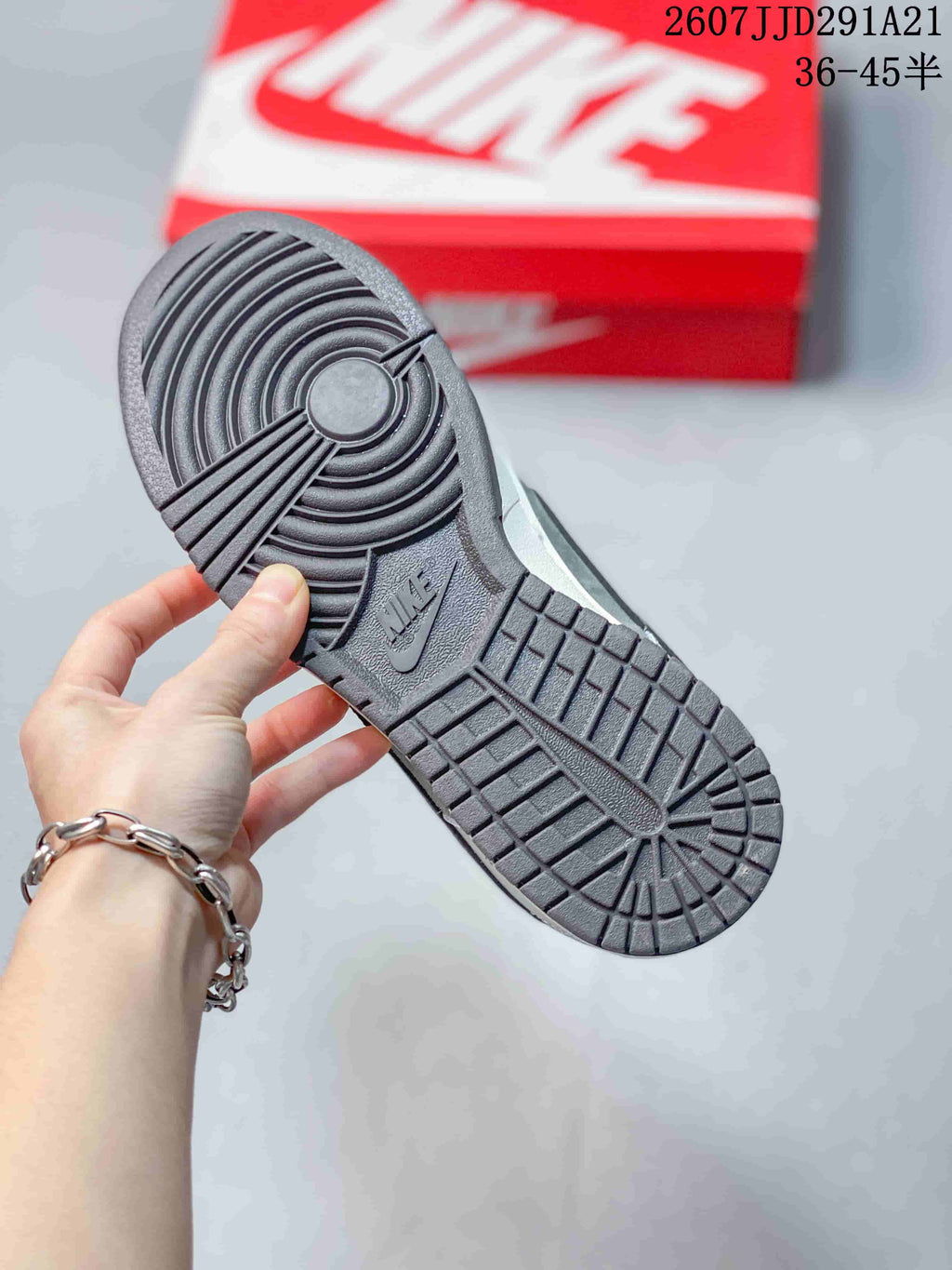 Close-up of the dark rubber outsole showing concentric traction patterns and a Nike logo.