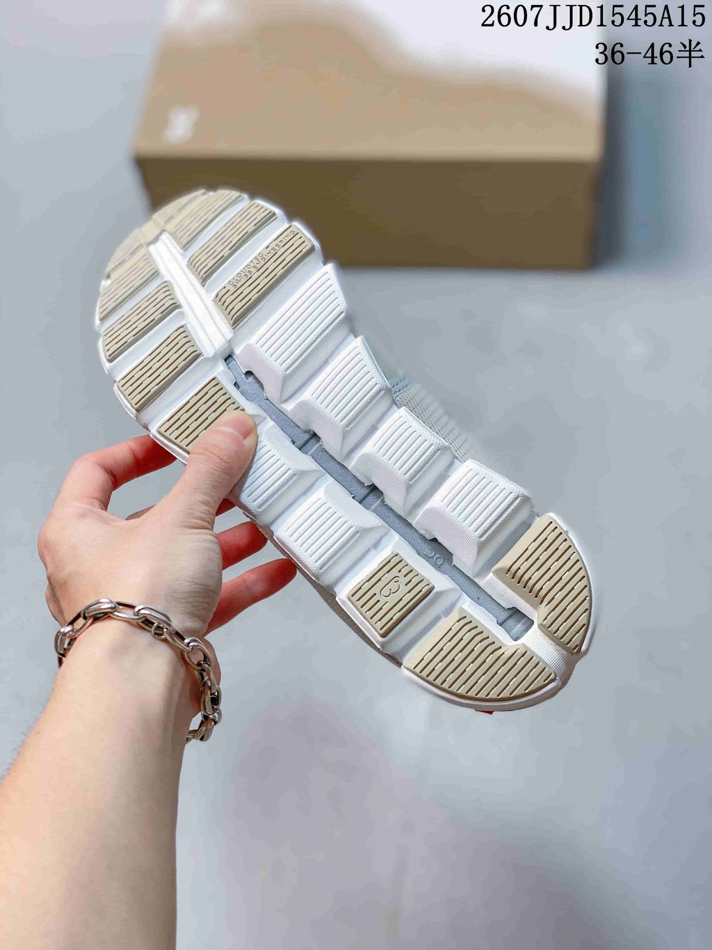 Underside view of the white segmented outsole showing its open-space construction and textured tread sections.