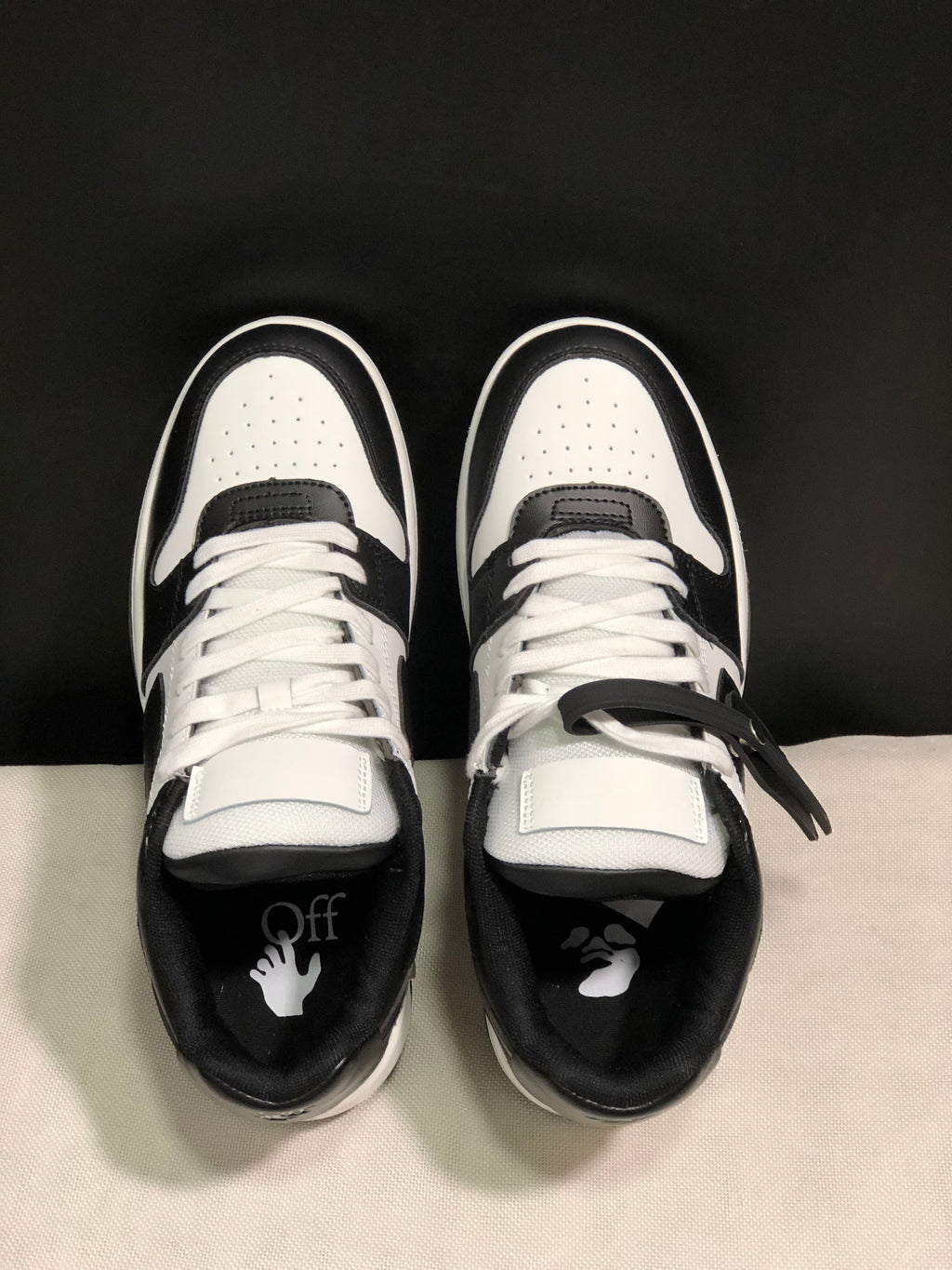 Top view showing white laces, perforated toe boxes, contrasting overlays, and graphic insoles.