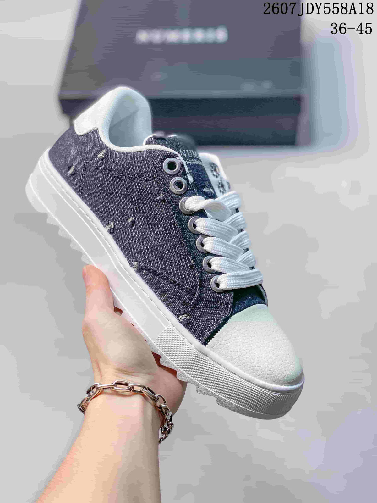 Dark gray NUMERIS low-top sneaker with white laces, white toe cap and contrasting stitched panels; image shows size range 36-45.