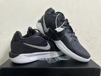Pair of black low-top basketball shoes with silver-tone Swoosh and white midsoles