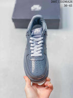 Top view of a grey sneaker showing the perforated toe box, white laces and Nike Air Force 1 tongue branding; image text shows 2607JJD296A26 and 36–45.