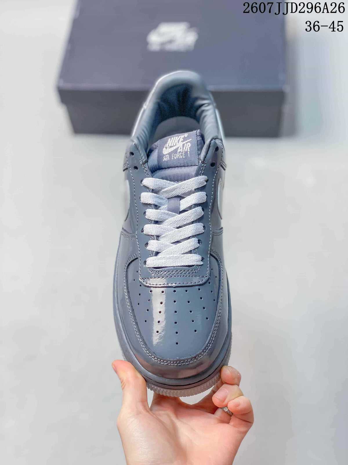 Top view of a grey sneaker showing the perforated toe box, white laces and Nike Air Force 1 tongue branding; image text shows 2607JJD296A26 and 36–45.