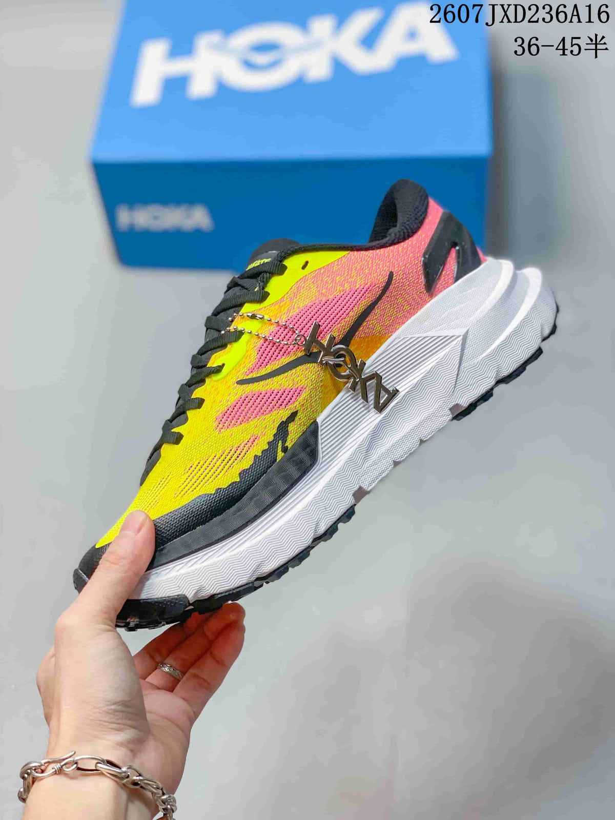 Side view of the MAFATE X trail running shoe showing its yellow and pink upper, black detailing, white midsole, and black outsole.