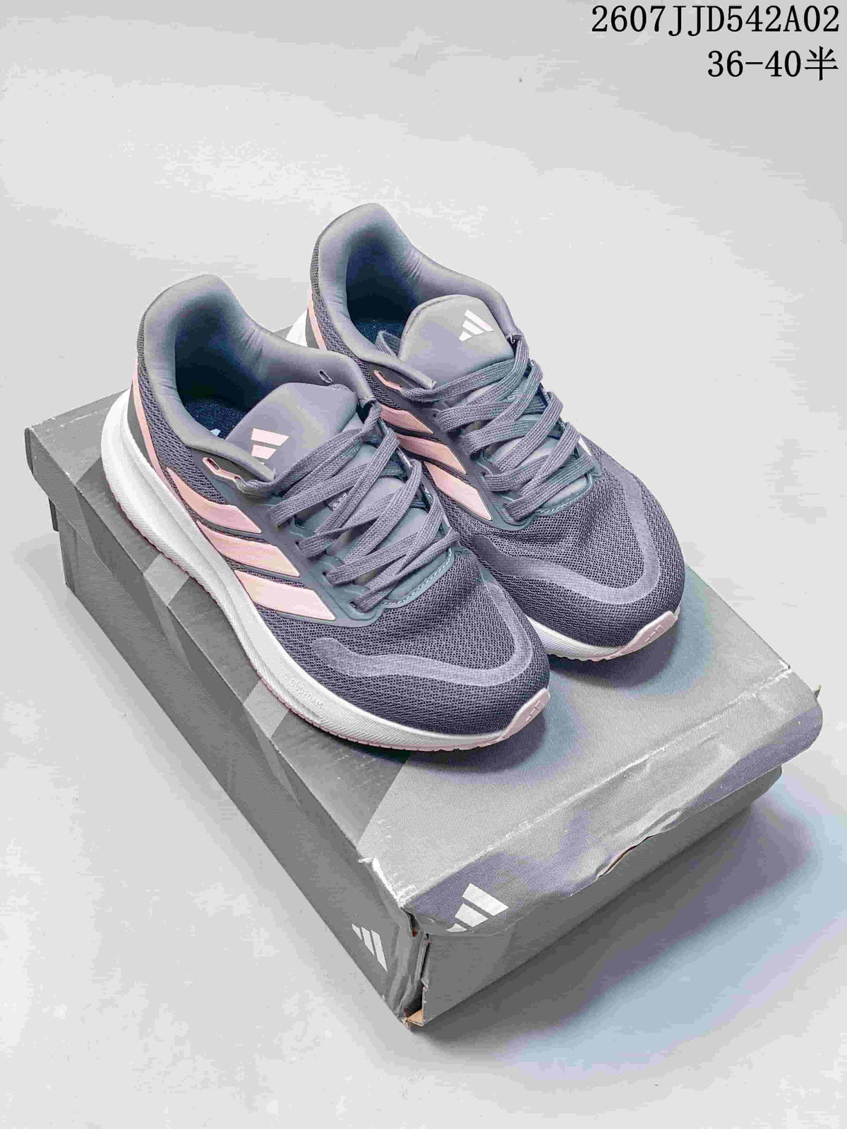 Pair of gray and pale pink Adidas Runfalcon 5 shoes displayed on a box.