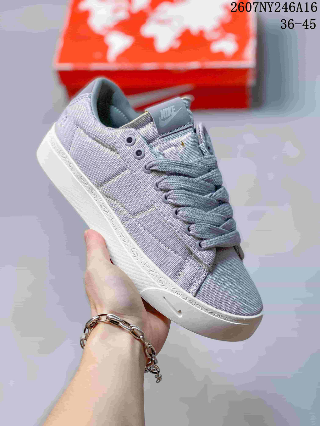 Close-up side view of a light lavender Nike sneaker with a white sole.