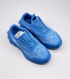 Top three-quarter view of the pair of blue Alo sneakers showing the tongues, laces and toe branding.